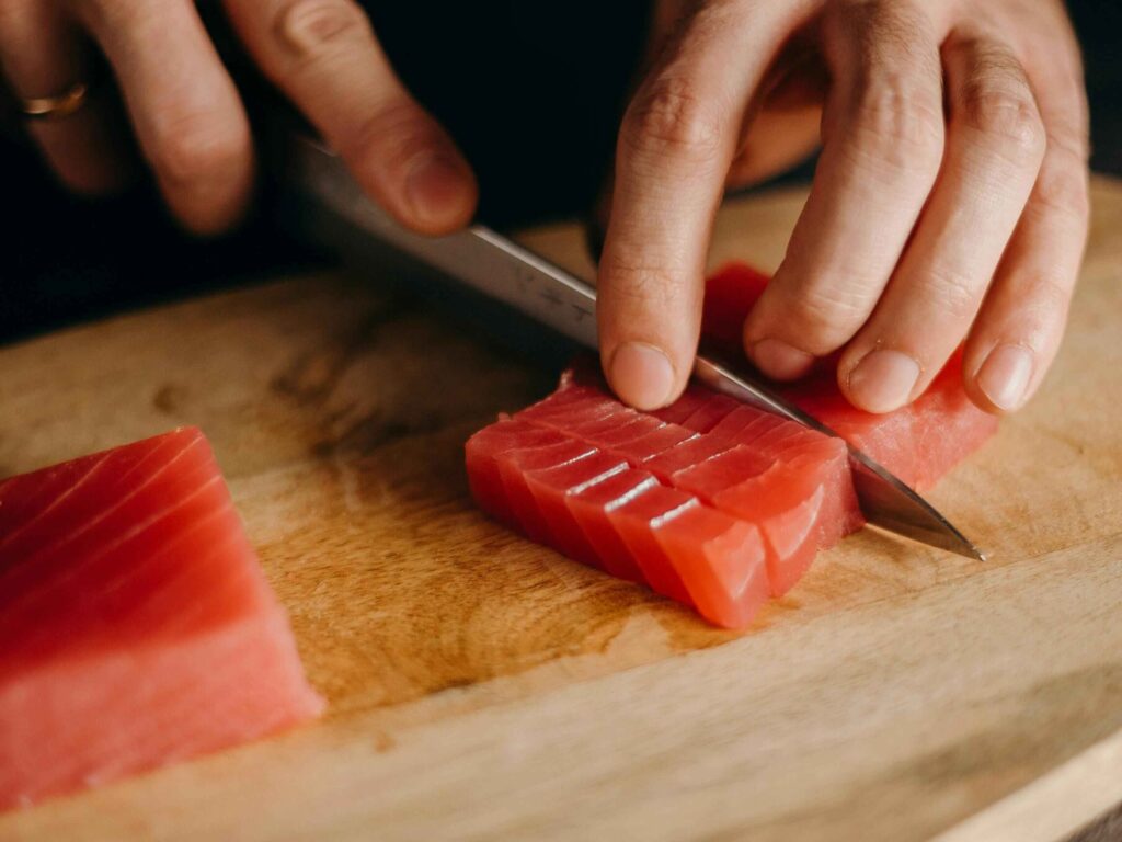 The precision cutting of salmon, highlighting its attention to detail.