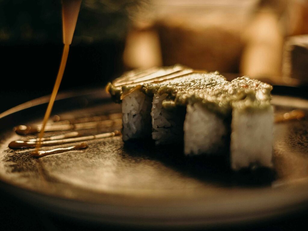 A sushi dish being prepared, presenting it as a form of art.