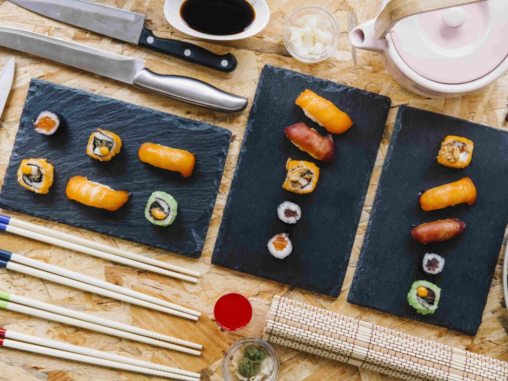 A neatly prepared sushi, complete with utensils for proper consumption.