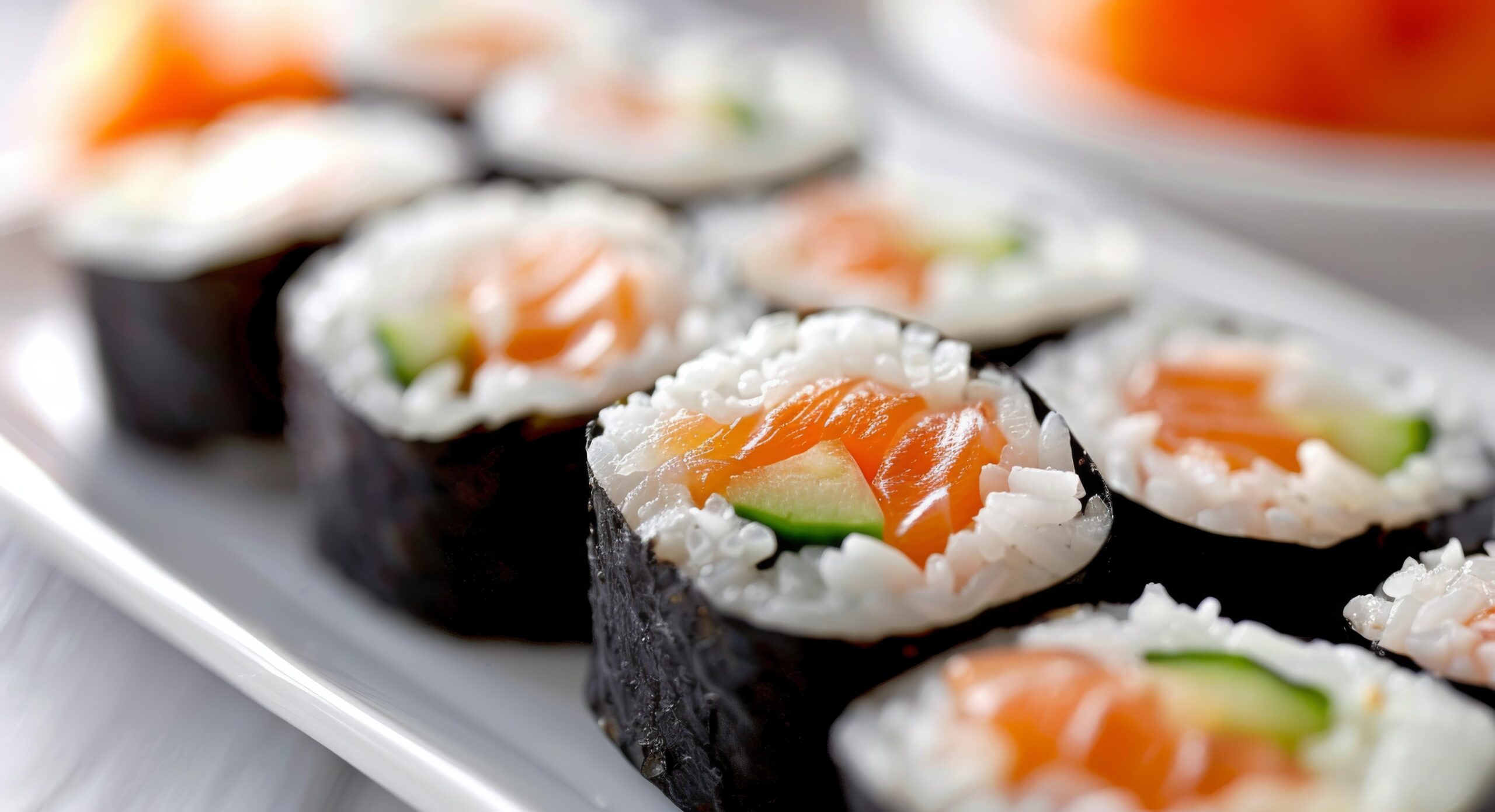 This is a close-up, shallow depth-of-field shot of a seafood pasta dish, prominently featuring open mussel shells standing upright on a bed of linguine.