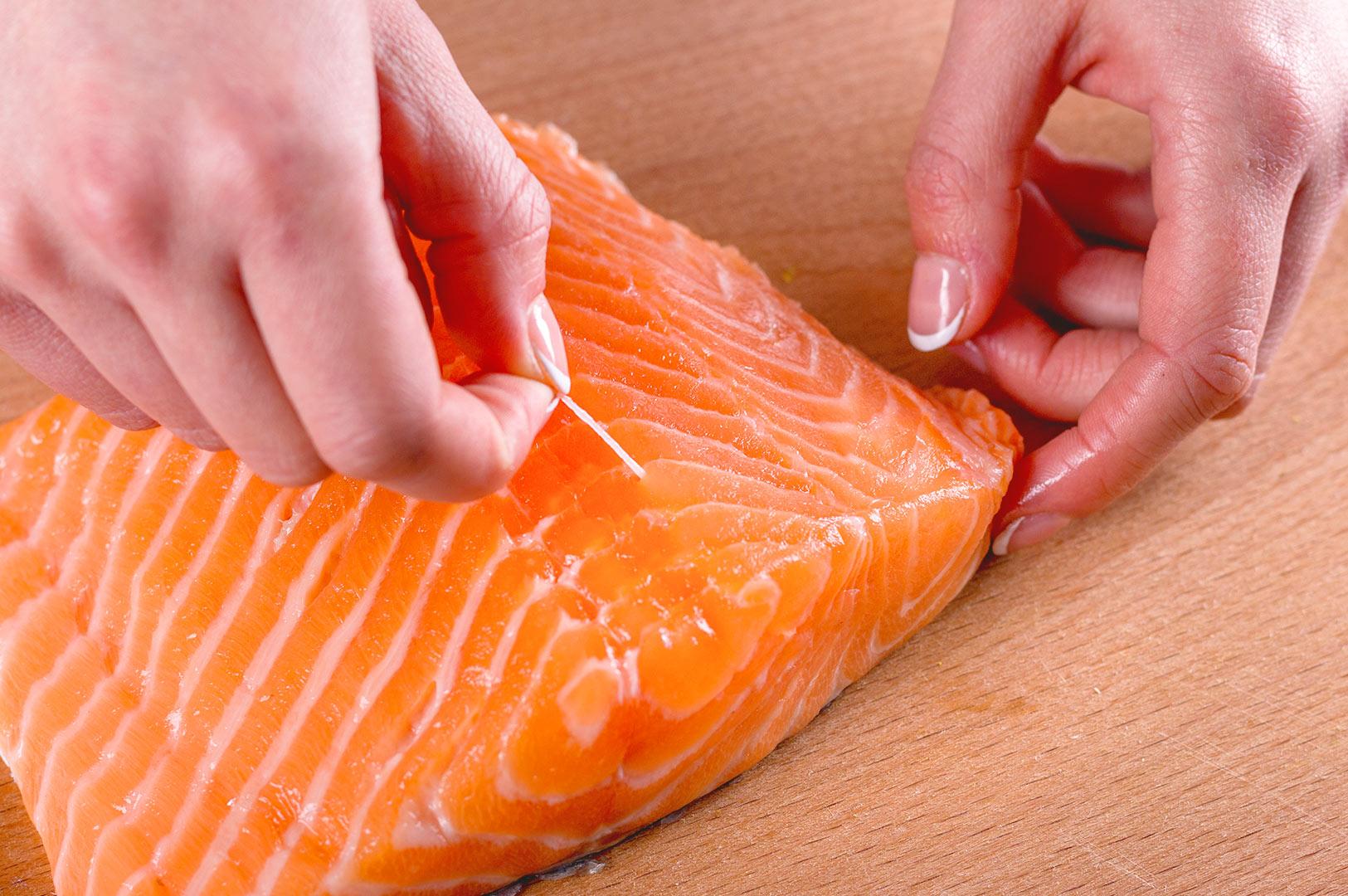 Removing pin bones from salmon fillet