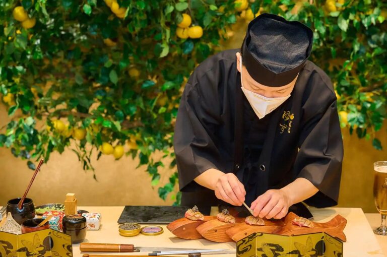 Omakase sushi chef preparing nigiri at a traditional sushi counter