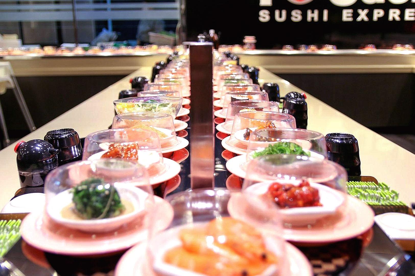 Sushi Express conveyor belt sushi close-up with assorted Japanese dishes