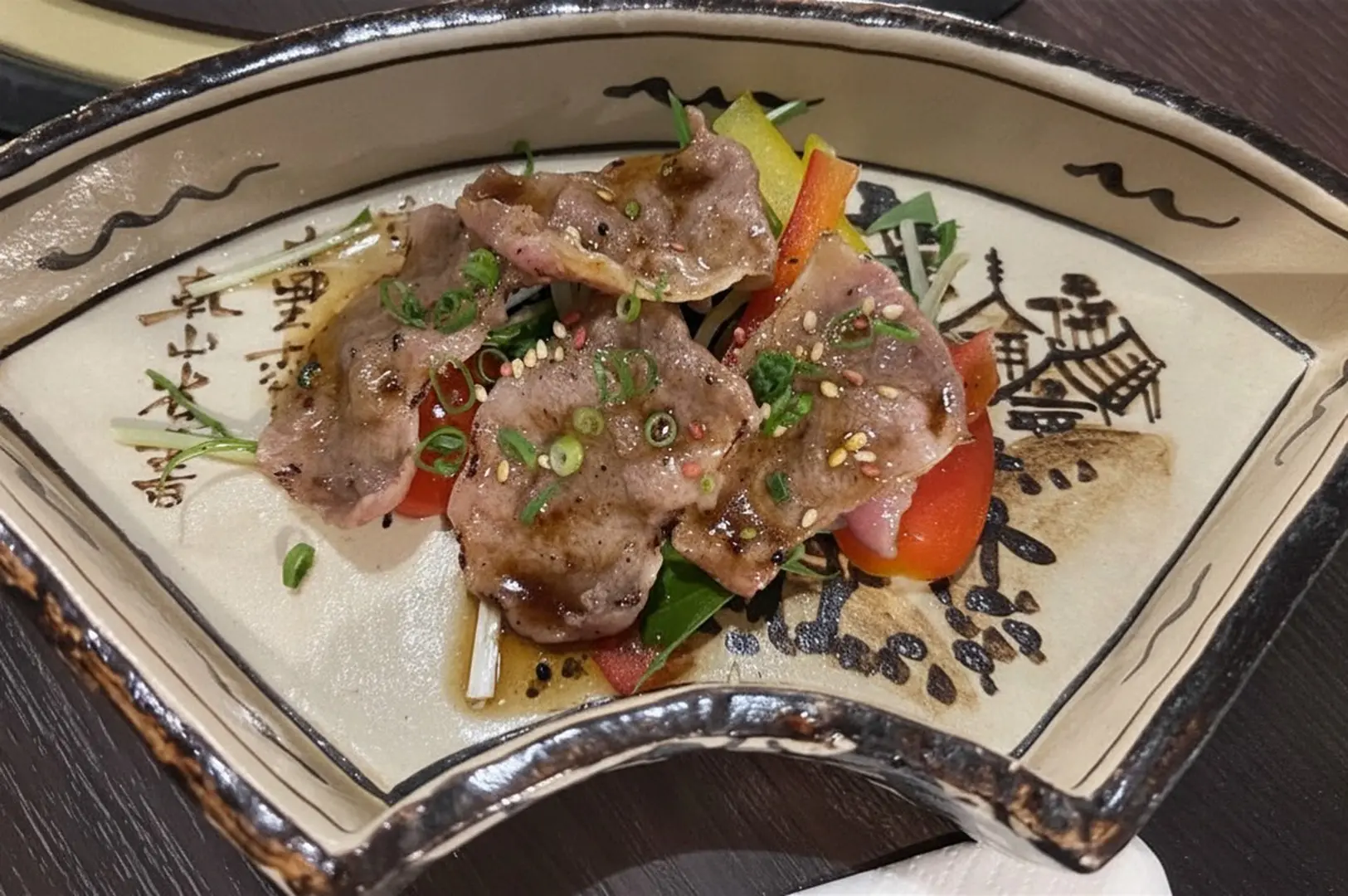 Seared fish with vegetables on decorative plate