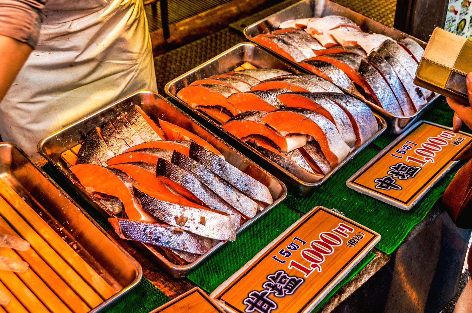 Fresh salmon fillets displayed at Tsukiji-style Japanese seafood market supplying sashimi restaurants in Singapore