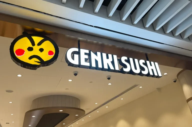 Genki Sushi storefront signage with yellow mascot logo
