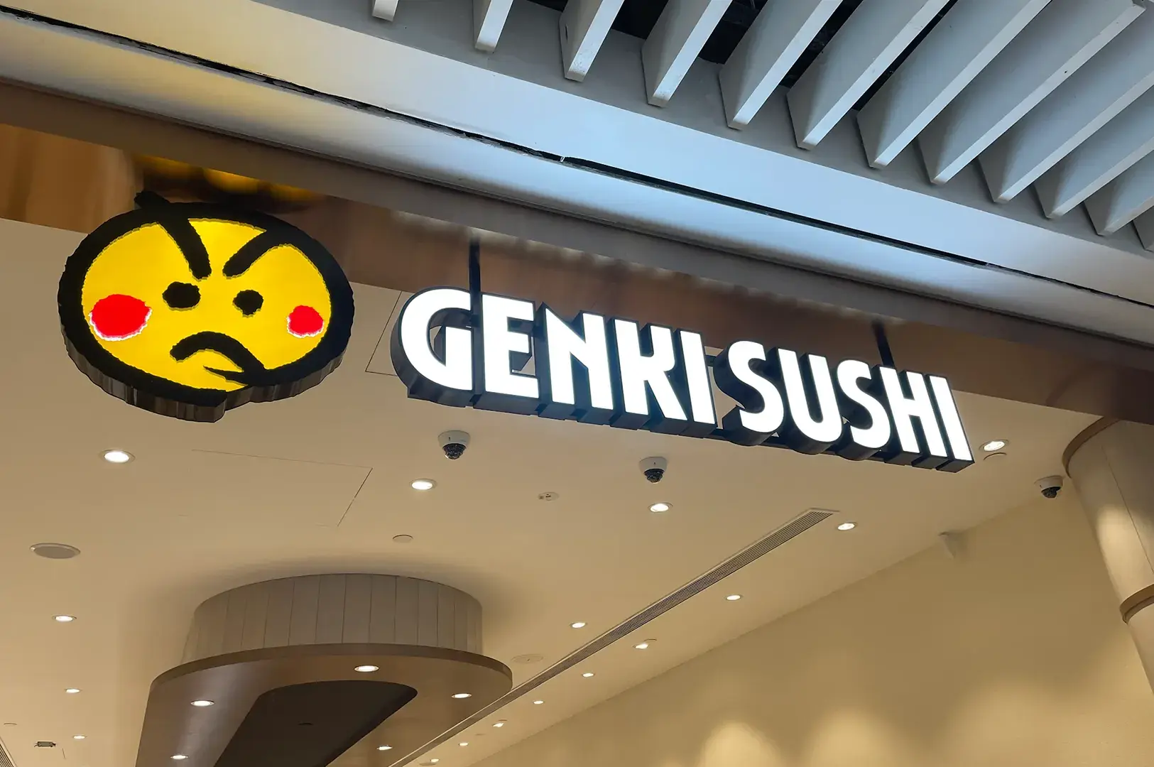 Genki Sushi storefront signage with yellow mascot logo
