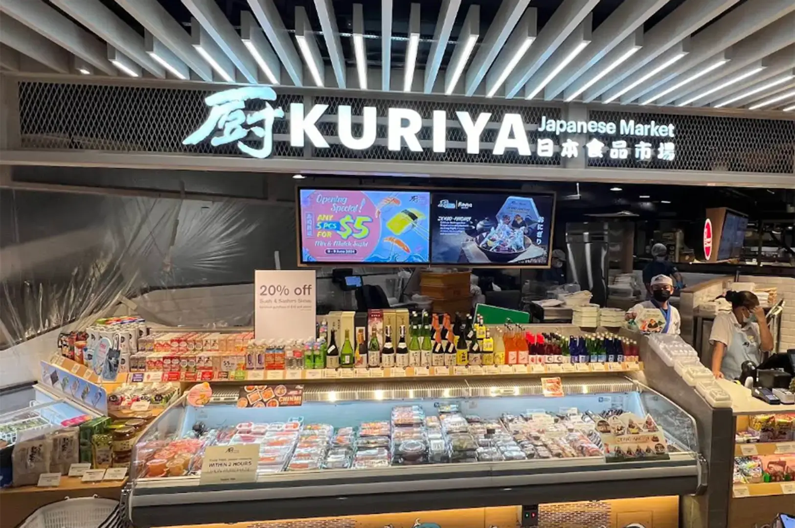 Kuriya Japanese Market counter with chilled seafood, packaged foods, bottled drinks, and Japanese signage.