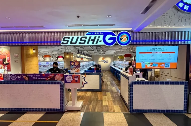 Sushi-Go restaurant entrance with blue branding, sushi displays, and a rewards sign.