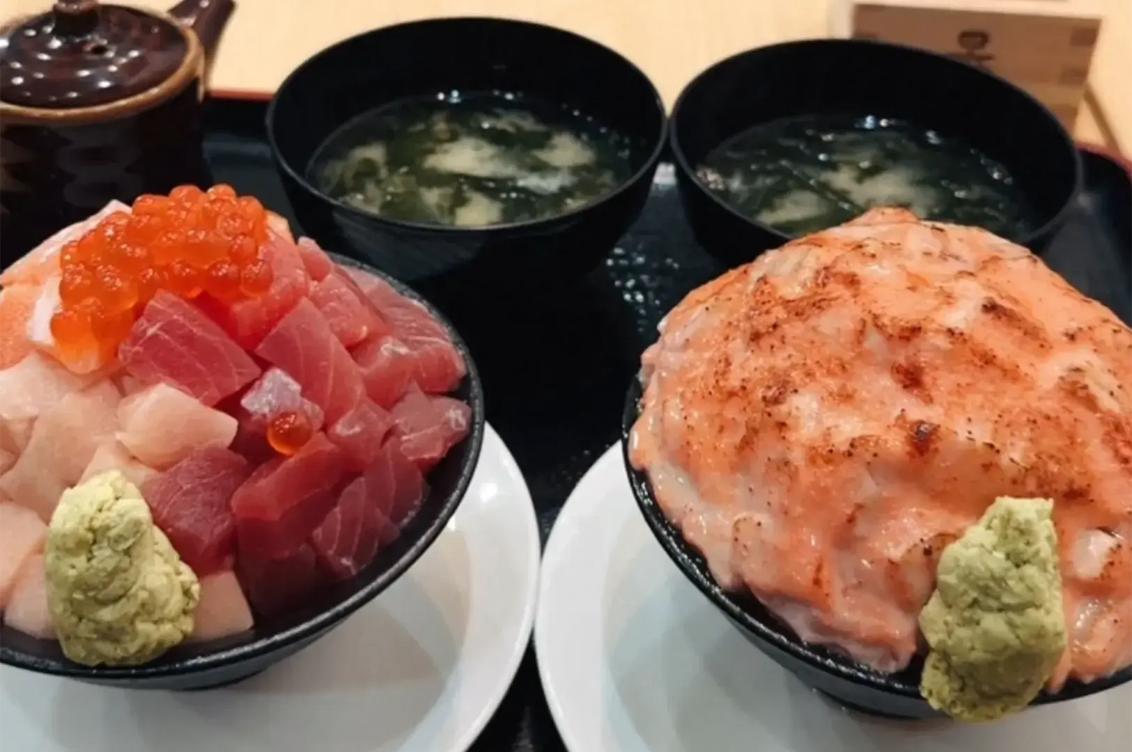Japanese set meal featuring seafood rice bowls served alongside hot miso soup and tea pot at Mita Sushi.